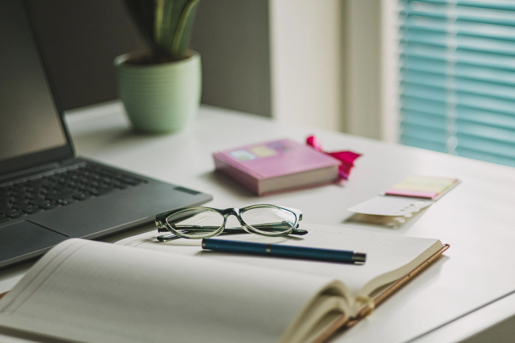 Professional planning desk with laptop and office supplies