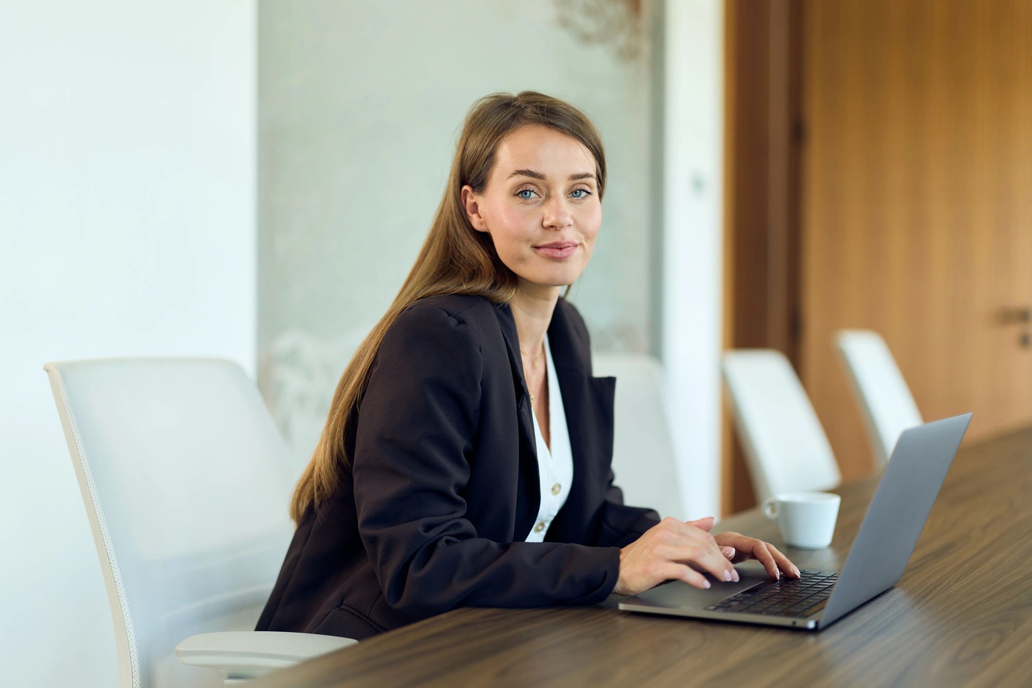 Professional consultant working on a laptop in a conference room