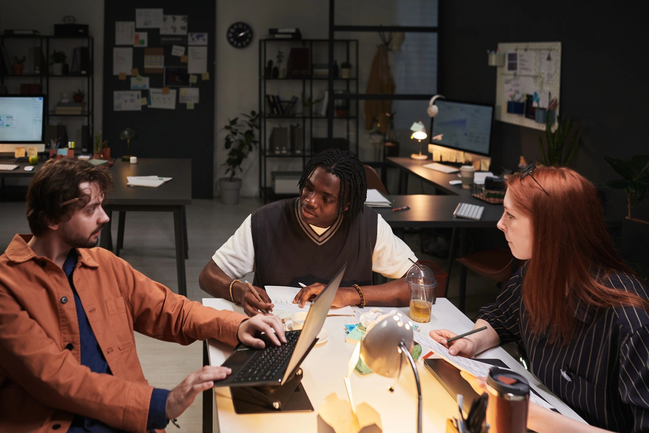 Small business team discussing strategy around a desk